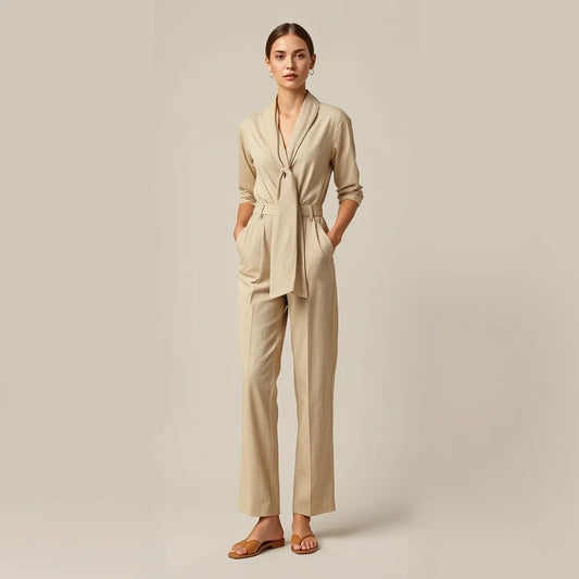 Model wearing a neck tie jumpsuit with a neatly draped scarf tie and tailored legs