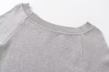 Slanted shoulder open shoulder long sleeved top